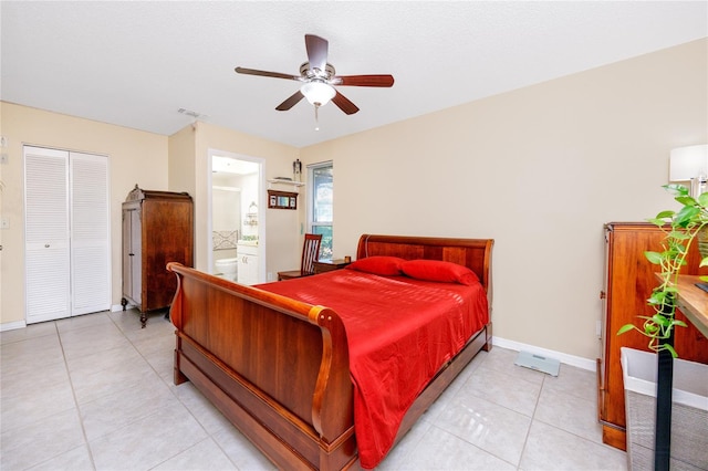 tiled bedroom with ensuite bathroom, a closet, and ceiling fan