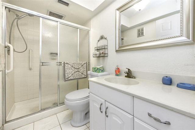 bathroom with vanity, toilet, tile patterned floors, and an enclosed shower