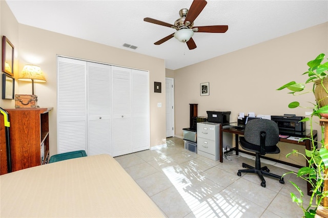 tiled office space featuring ceiling fan