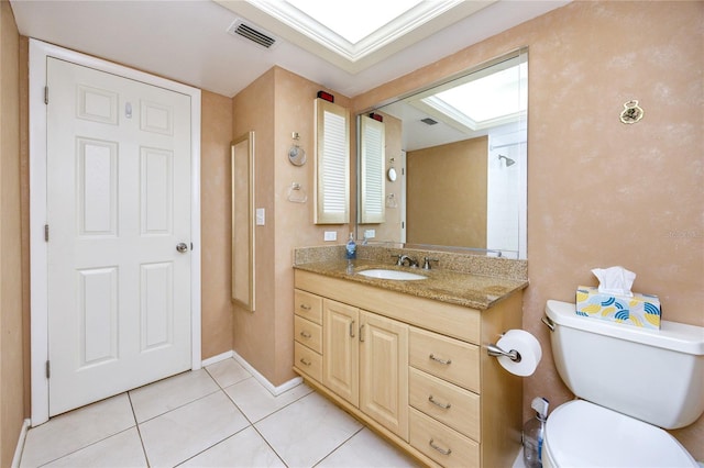 bathroom featuring vanity, toilet, and tile patterned flooring