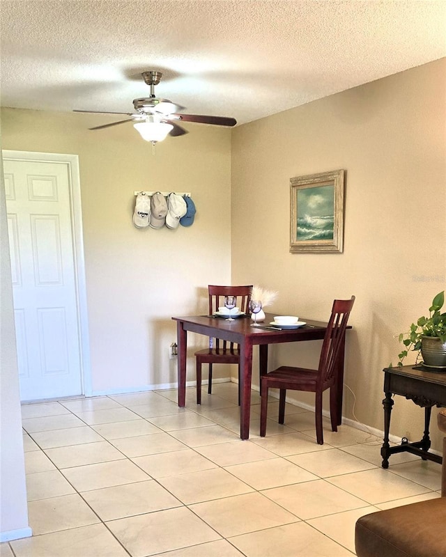 2390 Shelly Dr Unit D, Palm Harbor, FL 34684 - dining area featuring ceiling fan, light tile patterned floors, and a textured ceiling