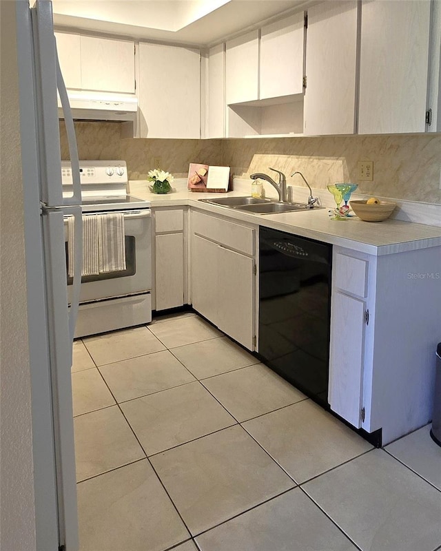 2390 Shelly Dr Unit D, Palm Harbor, FL 34684 - kitchen with white appliances, under cabinet range hood, light countertops, light tile patterned floors, and backsplash