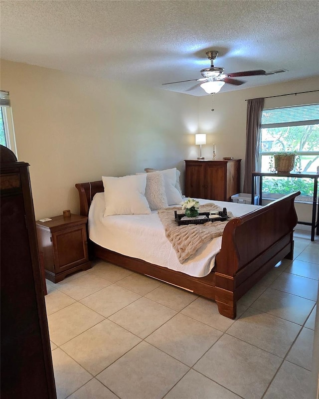 2390 Shelly Dr Unit D, Palm Harbor, FL 34684 - bedroom featuring a textured ceiling, ceiling fan, and light tile patterned floors