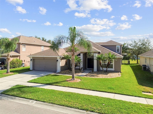 view of front of property with central AC unit, a front yard, and a garage