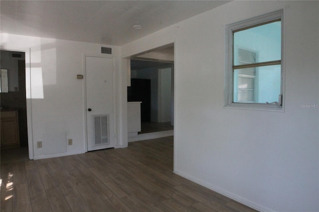 spare room featuring dark hardwood / wood-style flooring