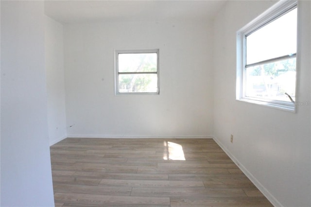 unfurnished room with wood-type flooring