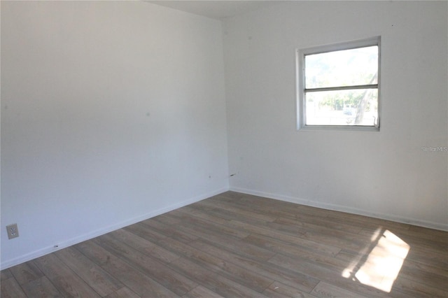 spare room featuring dark hardwood / wood-style floors