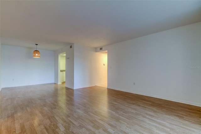 unfurnished room with light hardwood / wood-style flooring