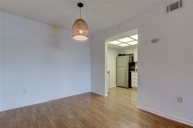 unfurnished room featuring light hardwood / wood-style floors