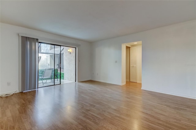 empty room with light hardwood / wood-style flooring