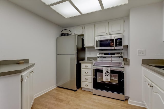 kitchen featuring appliances with stainless steel finishes, light hardwood / wood-style floors, and white cabinets