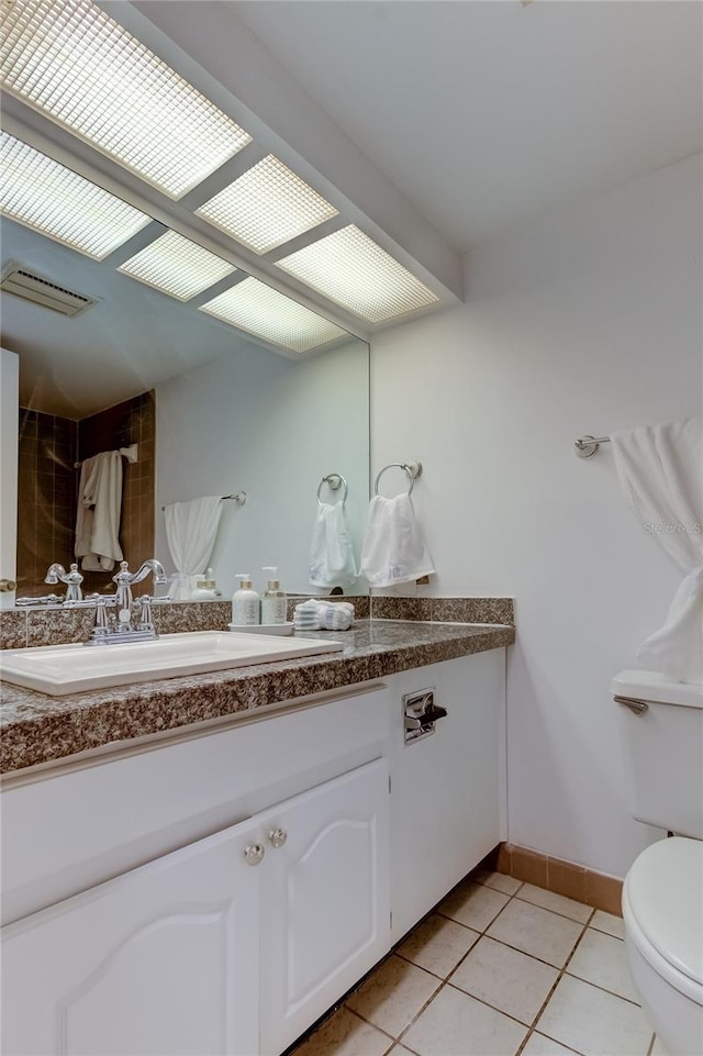 bathroom featuring tile patterned floors, vanity, and toilet