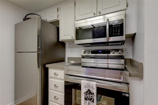 kitchen featuring white cabinetry and appliances with stainless steel finishes