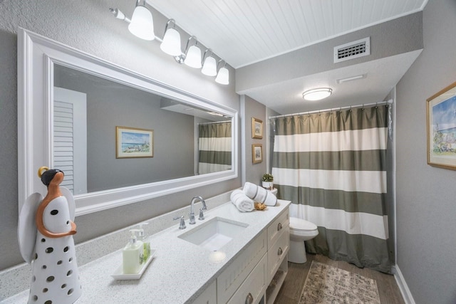 bathroom featuring vanity, hardwood / wood-style floors, a shower with shower curtain, and toilet