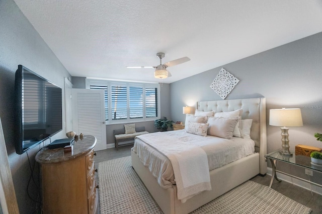 bedroom with a textured ceiling and ceiling fan