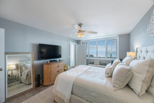 bedroom with light hardwood / wood-style floors and ceiling fan