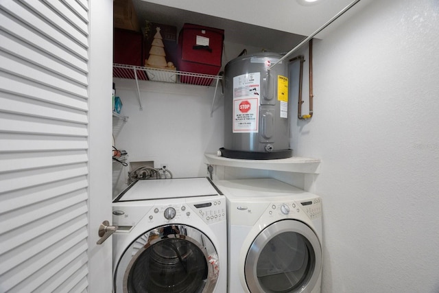 washroom featuring electric water heater and washing machine and clothes dryer