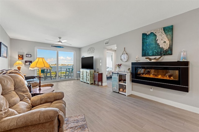 living room with hardwood / wood-style flooring and ceiling fan