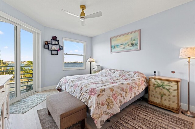 bedroom with access to exterior, light hardwood / wood-style flooring, and ceiling fan