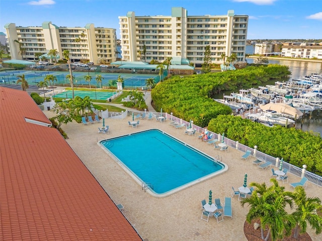 view of swimming pool with a water view and a patio