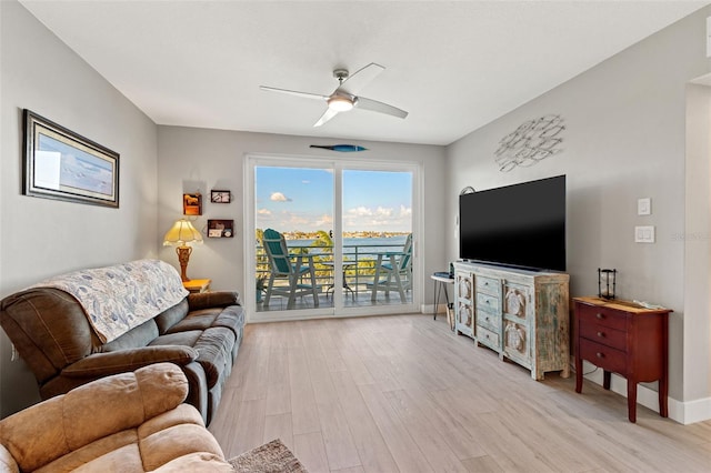 living room with ceiling fan and light hardwood / wood-style floors