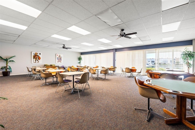 recreation room with a paneled ceiling, ceiling fan, and carpet floors