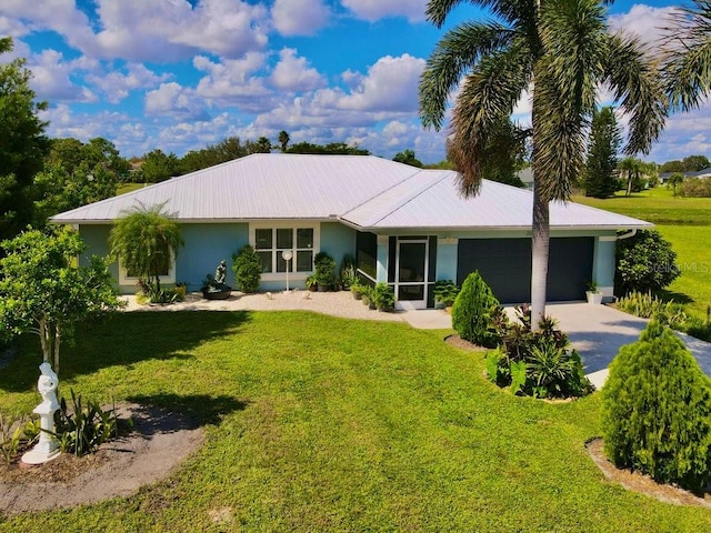 view of front of house with a garage and a front yard