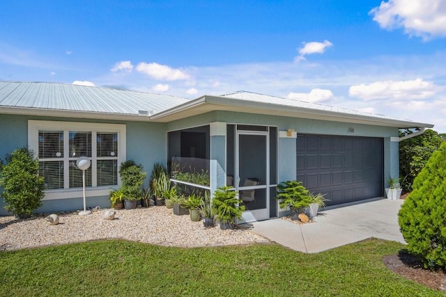 view of side of property featuring a garage and a lawn