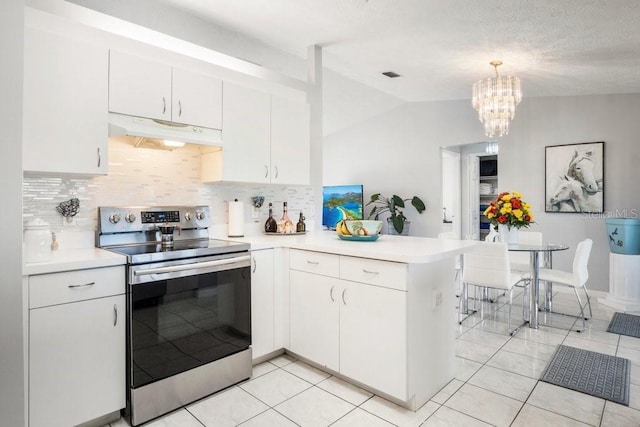 kitchen with kitchen peninsula, stainless steel range with electric stovetop, vaulted ceiling, decorative light fixtures, and white cabinetry