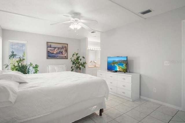 bedroom featuring light tile patterned floors, ensuite bath, and ceiling fan