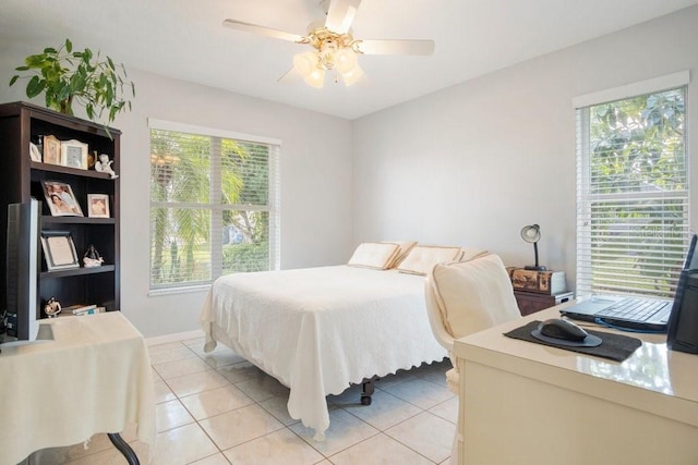 tiled bedroom with multiple windows and ceiling fan