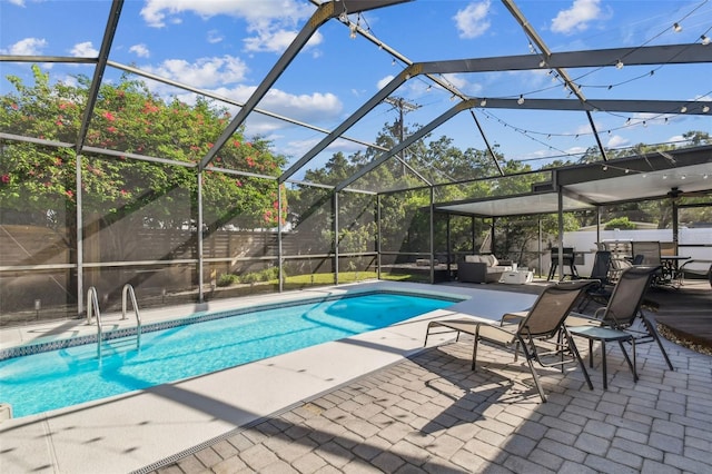 view of swimming pool featuring glass enclosure and a patio area