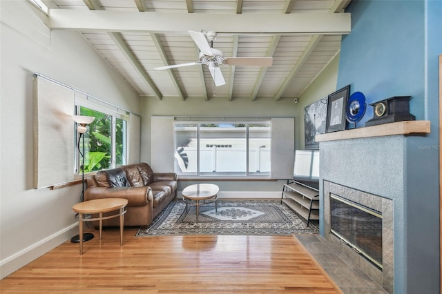 living room with vaulted ceiling with beams, wood-type flooring, wooden ceiling, and ceiling fan