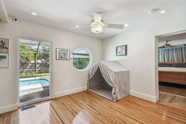 interior space with hardwood / wood-style floors and ceiling fan