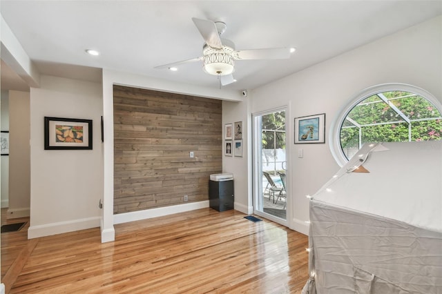 interior space with a wealth of natural light, ceiling fan, and light hardwood / wood-style floors