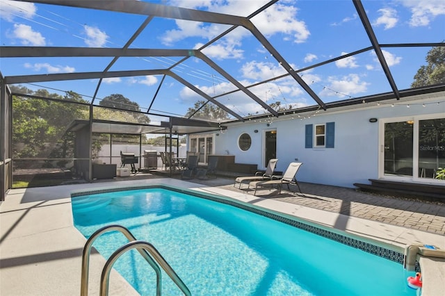 view of swimming pool with a patio and glass enclosure