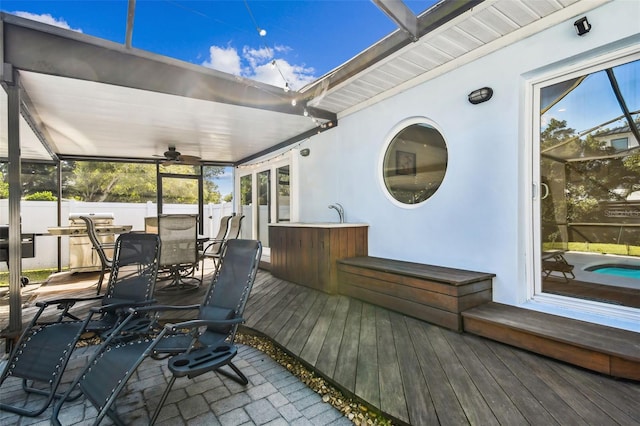 view of patio / terrace with grilling area, ceiling fan, and a deck