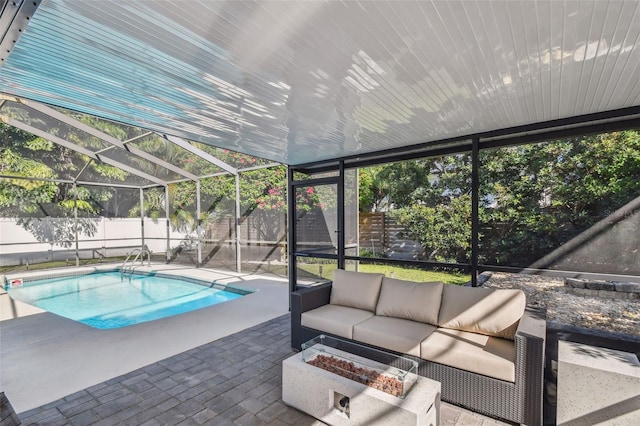 view of pool with outdoor lounge area, glass enclosure, and a patio area