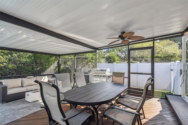 sunroom / solarium featuring ceiling fan