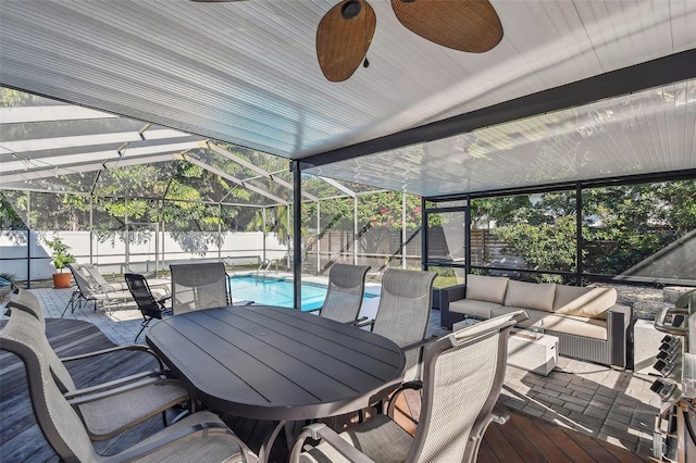 exterior space with a fenced in pool, a patio area, ceiling fan, a lanai, and an outdoor hangout area