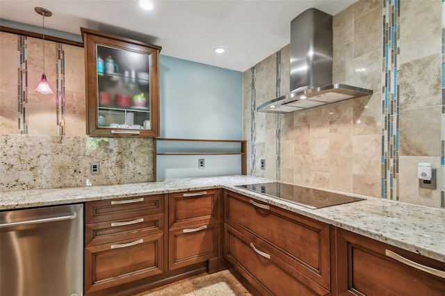 kitchen with wall chimney exhaust hood, black electric stovetop, decorative light fixtures, and light stone countertops