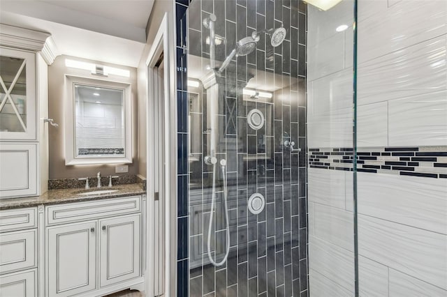 bathroom featuring vanity and a shower with door