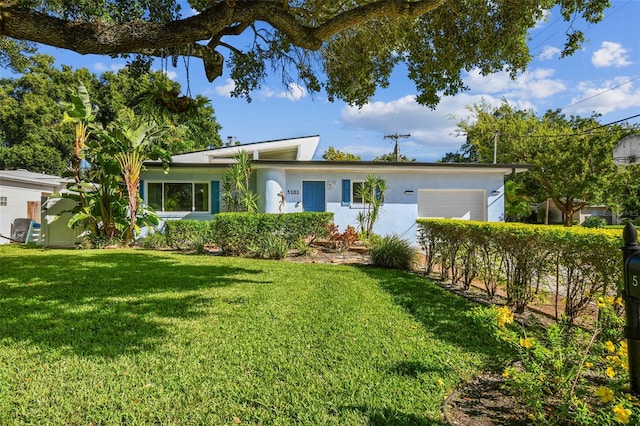 ranch-style house with a front lawn and a garage