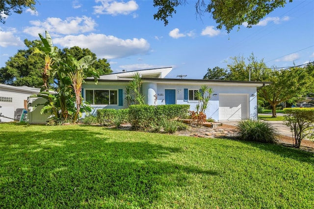 ranch-style house featuring a garage and a front lawn