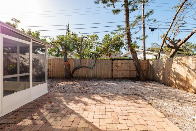 view of patio with a sunroom