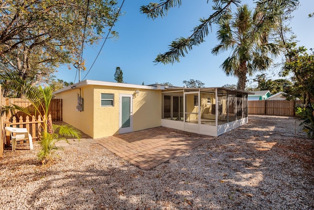 back of property featuring a patio and a sunroom