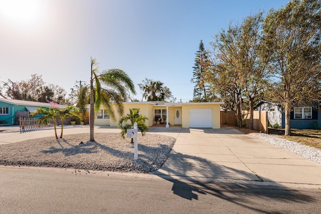 6614 10th Avenue Terrace S, Saint Petersburg, FL 33707 - ranch-style home featuring fence, an attached garage, concrete driveway, and stucco siding