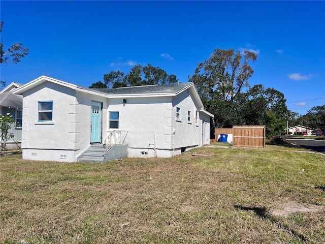 rear view of property with a lawn