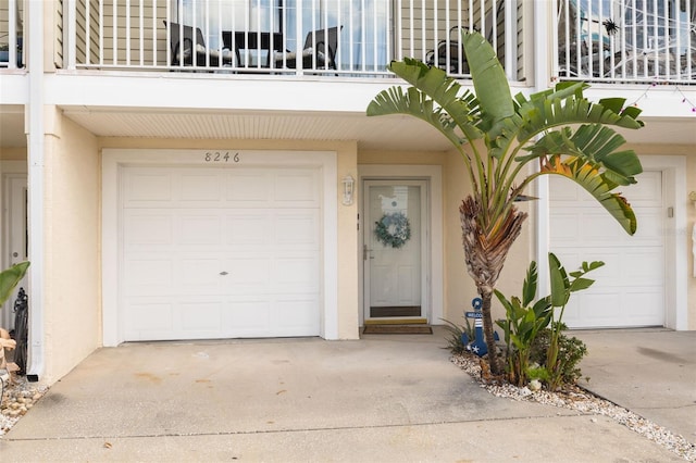 property entrance featuring a balcony and a garage