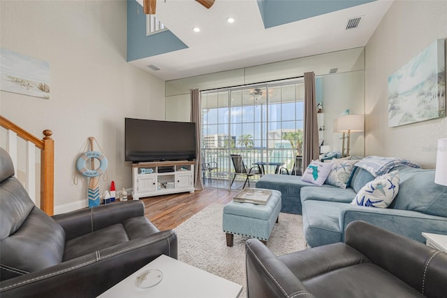 living room with hardwood / wood-style floors and ceiling fan